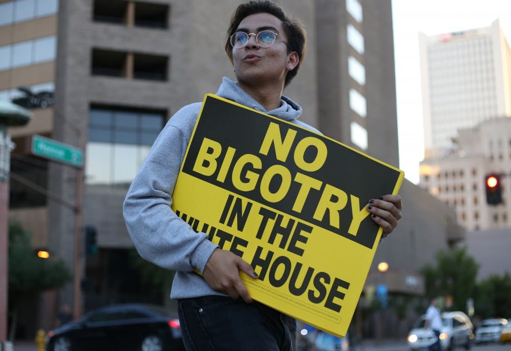A protestor marches around downtown Phoenix during a Trump rally on Wednesday, Aug. 31, 2016.