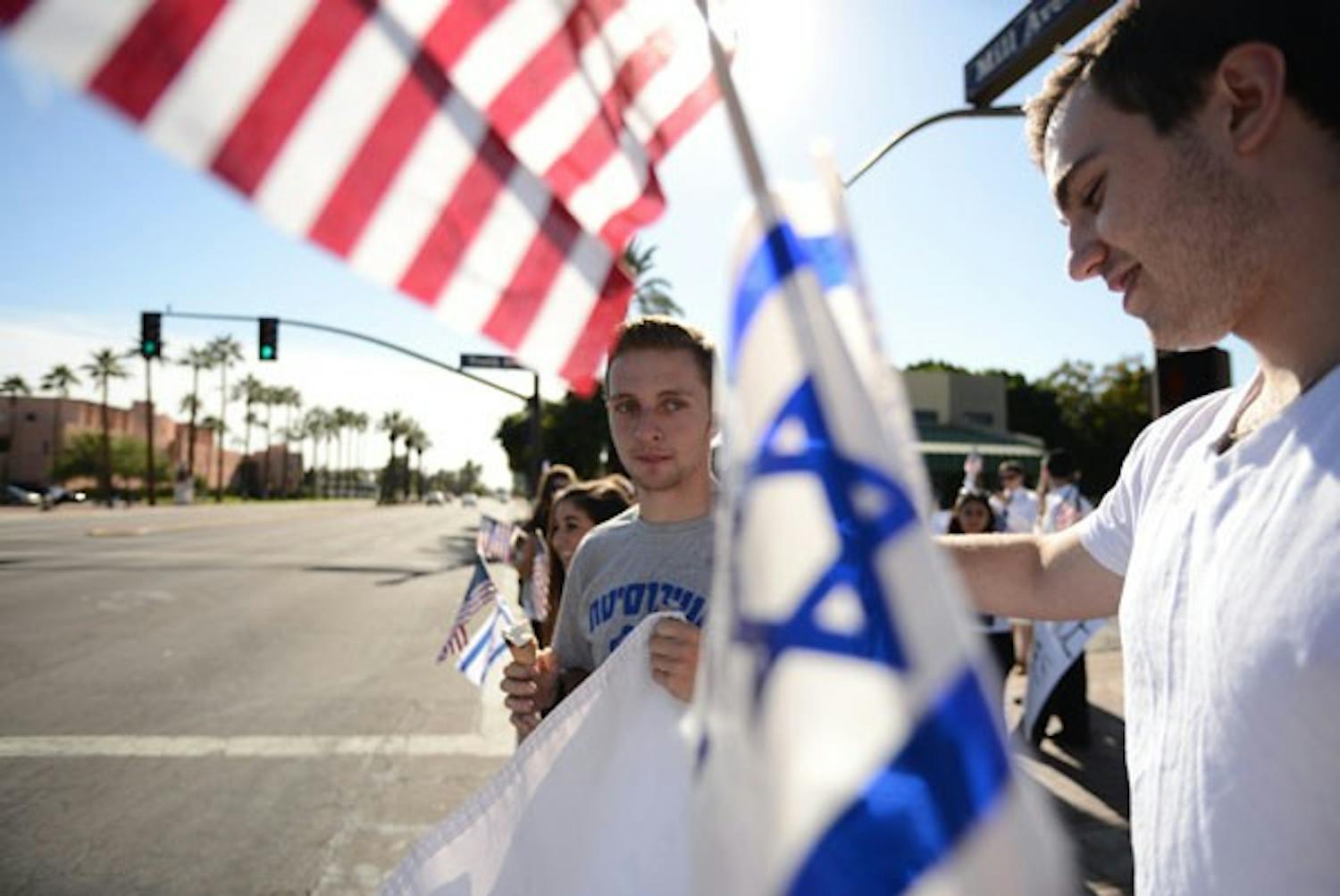 Finance and economics sophomore Jared Hirschl (left) and finance and supply chain management sophomore Sam Levine wait at the stop light at Mill and Tenth Street after departing the Student Hillel Center for the "Stand for Israel" march on Wednesday afternoon. (Photo by Aaron Lavinsky)