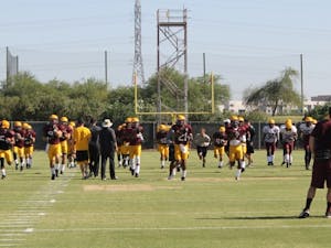 ASU football players warm up during practice on Aug. 5 in Tempe, Ariz. (Photo by Justin Janssen)