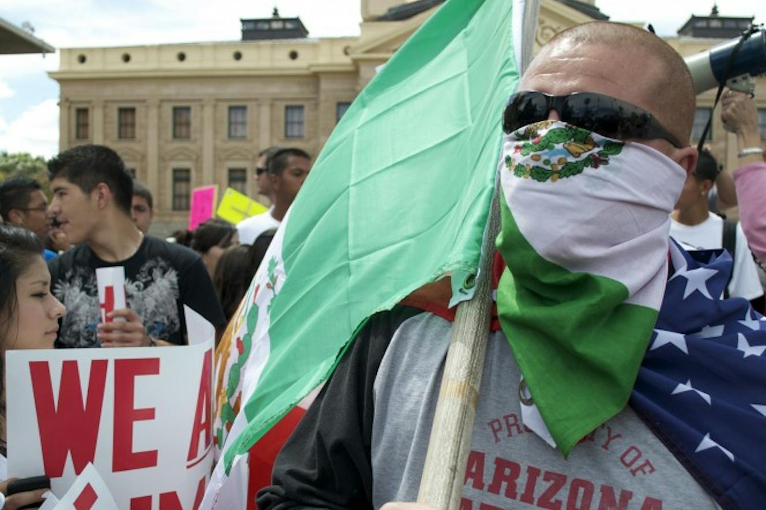 Marcell Chavez, of Phoenix, wore both an American flag and a Mexican flag to the rally to protest SB 1070, the immigration bill signed by Gov. Brewer Friday afternoon. (MOLLY SMITH | THE STATE PRESS)