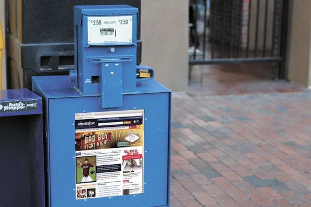 A newspaper box is seen on the corner of 6th Street and Mill Avenue late Wednesday. Media outlets are implementing online paywall systems, which limit the amount of content non-subscribers have access to.  (Photo by Sam Rosenbaum) 