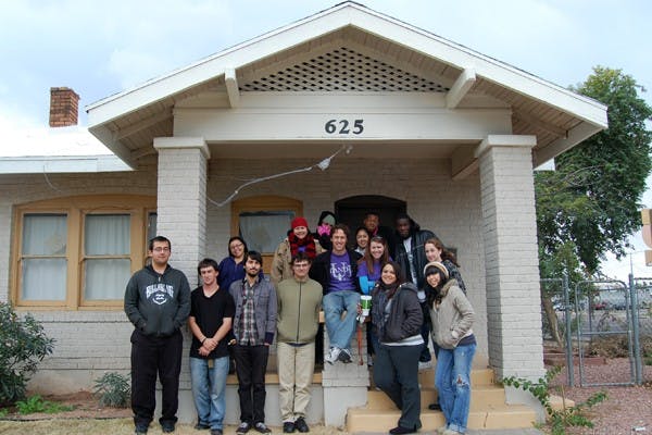 Timothy Huffman, Stand Up volunteers and homeless youth pose in front of "Our House" in Phoenix. The house offers support to homeless youth in the area. (Photo by Thania Betancourt)