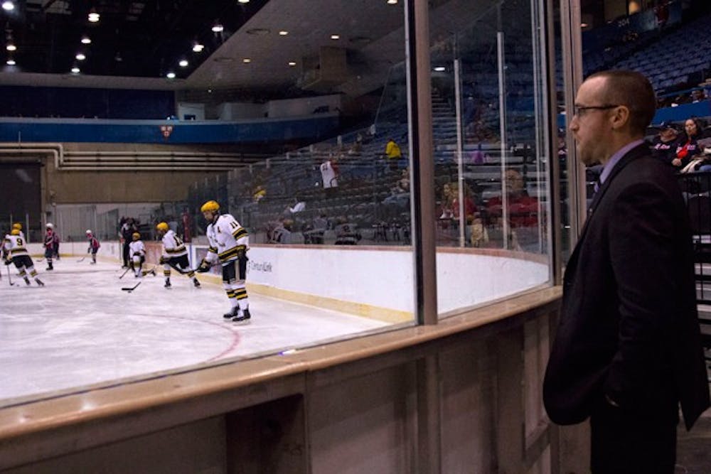 Coach Greg Powers watches the ASU Division I team during practice in the 2013 season before the night’s game against UA. (Photo by Ana Ramirez)
