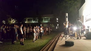 Students watch as Breakup Shoes performs&nbsp;in the Tempe Secret Garden on Thursday, August 25.