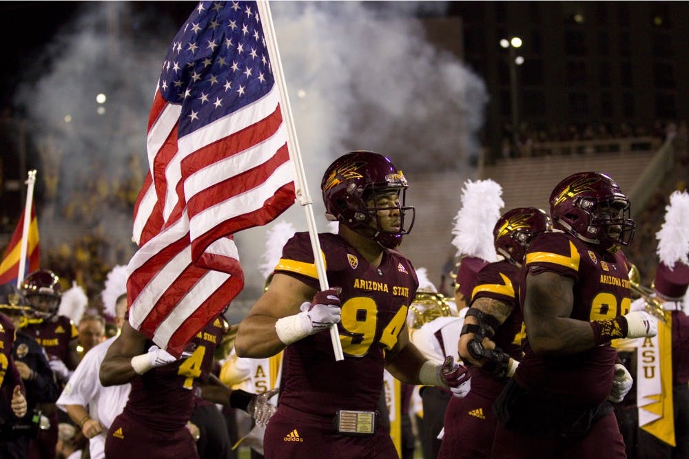 Arizona State Sun Devils defensive lineman Christian Hill (94) carries the American flag out through the Tillman Tunnel for the Sun Devils before the game versus the California Golden Bears in Sun Devil Stadium in Tempe, Arizona, on Saturday, Sept. 24, 2016. At half the Sun Devils are losing 10-24.