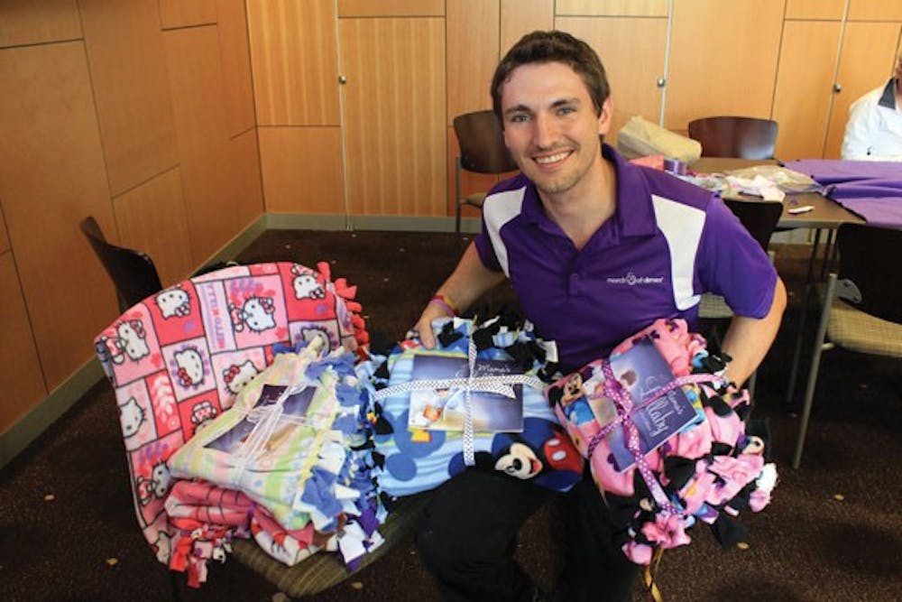 Film junior Jared Doles shows off the blankets ASU March of Dimes club made for sick babies and their families. This project was funded by the Miley Cyrus and Youth Service America "Get Ur Good On" grant. (Photo courtesy of  Jared Doles)