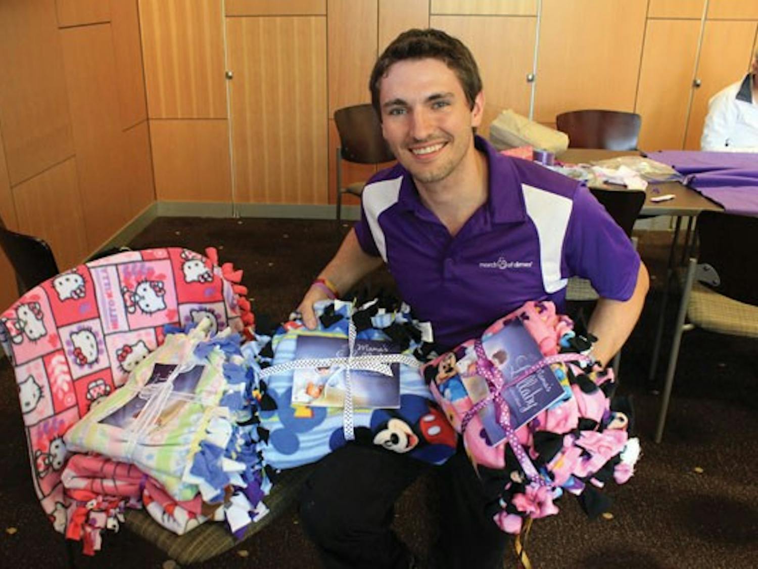 Film junior Jared Doles shows off the blankets ASU March of Dimes club made for sick babies and their families. This project was funded by the Miley Cyrus and Youth Service America "Get Ur Good On" grant. (Photo courtesy of  Jared Doles)