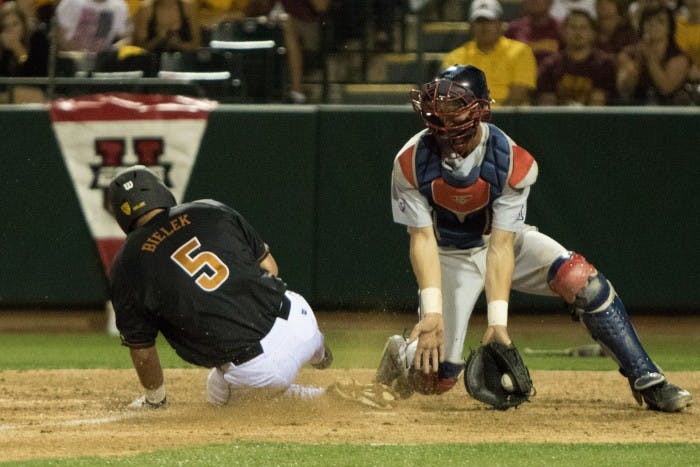 Senior Joey Bielek scores off a sacrifice fly by junior Johnny Sewald in the bottom of the fifth inning against University of Arizona at Phoenix Municipal Stadium Saturday, April 11, 2015. The Sun Devils defeated the Wildcats 5-4. 