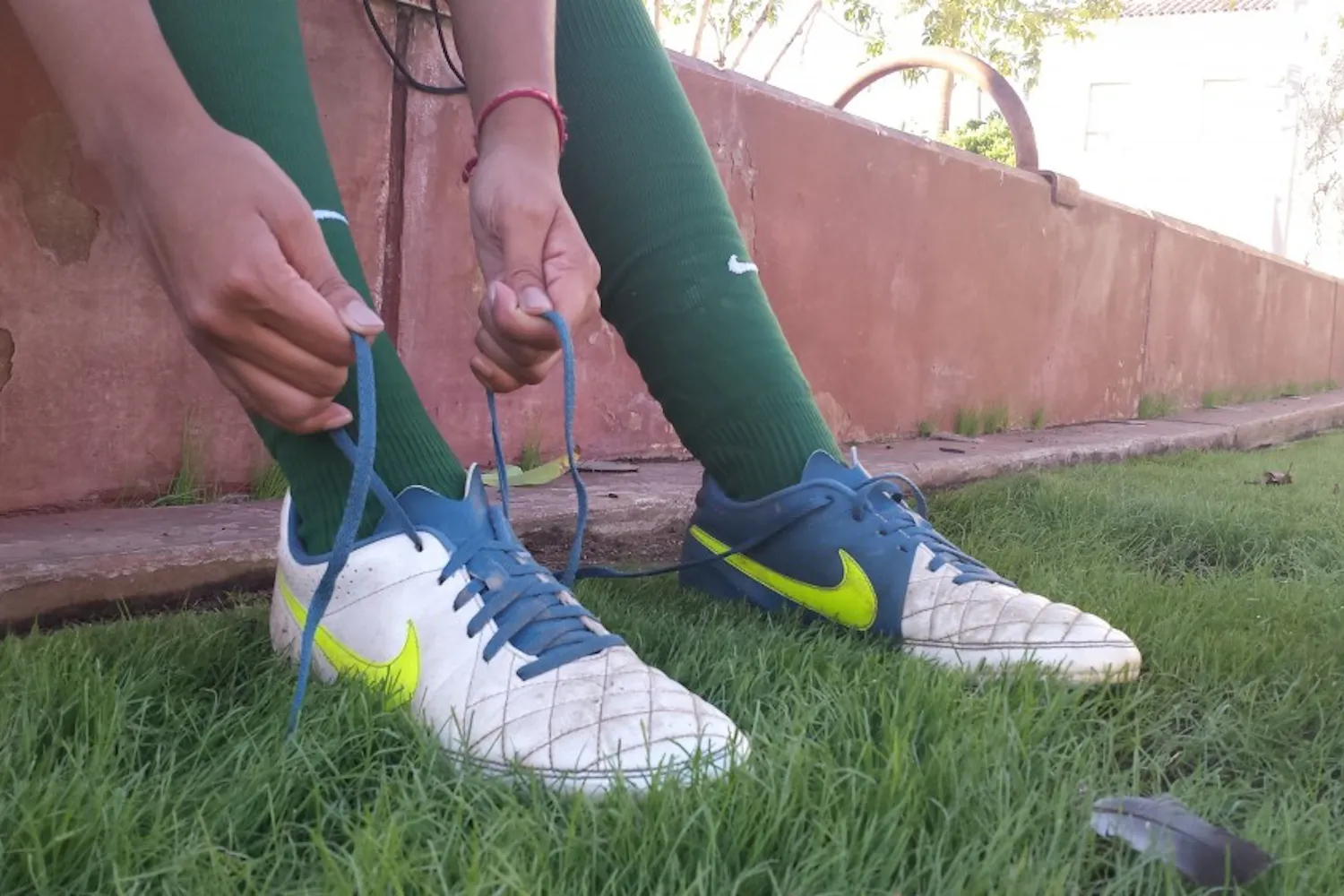 Photo illustration of a cleat being laced up.