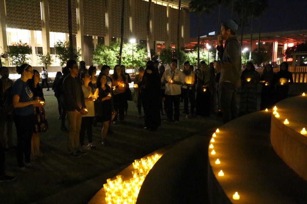 Students gather on Hayden Lawn on Wednesday, March 2, 2016, at the Interfaith Candlelight Vigil held in honor of the shooting victims killed in Fort Wayne, Indiana. The vigil was hosted by the Sun Devils are Better Together and ASU's Muslim Students Association. 