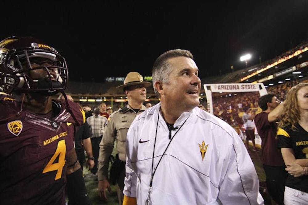 Junior safety Alden Darby (left) and coach Todd Graham look off to the student section after the Sun Devils’ 45-14 win over Illinois on Saturday. (Photo by Sam Rosenbaum)