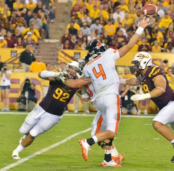 WATCH OUT: ASU senior defensive end Jamaar Jarrett (92) fights to reach OSU redshirt freshman quarterback Sean Mannion during the Sun Devils’ 35-20 win on Saturday. Jarrett’s performance on defense has opposing teams looking to avoid him. (Photo by Aaron Lavinsky)