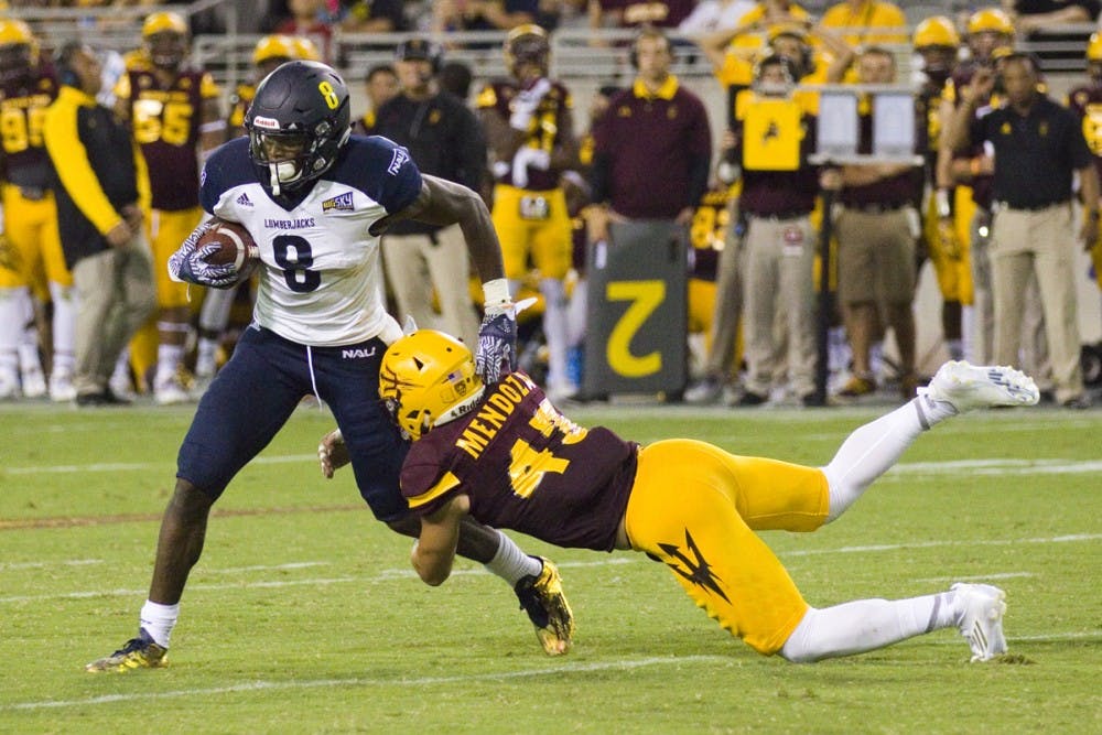 Arizona State redshirt senior linebacker Carlos Mendoza tries to tackle NAU junior wide receiver Emmanuel Butler during the 44-13 victory against the Northern Arizona University Lumberjacks in Sun Devil Stadium in Tempe, Arizona, on Saturday, September 3, 2016.