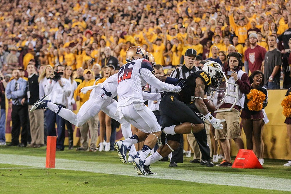 Redshirt sophomore receiver Jaelen Strong is pushed out of bounds by two UA defenders. (Photo by Arianna Grainey)