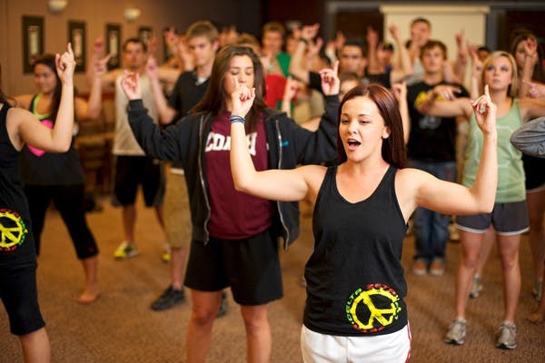 GREEK GROOVIN: Rachael Roberts, a sister in the Delta Zeta sorority, leads a group of brothers from the Lambda Chi Alpha and Tau Kappa Epsilon fraternities in her group's routine for the upcoming Greek sing and dance competition on Monday, part of the Greek Week activities. (Photo by Michael Arellano)