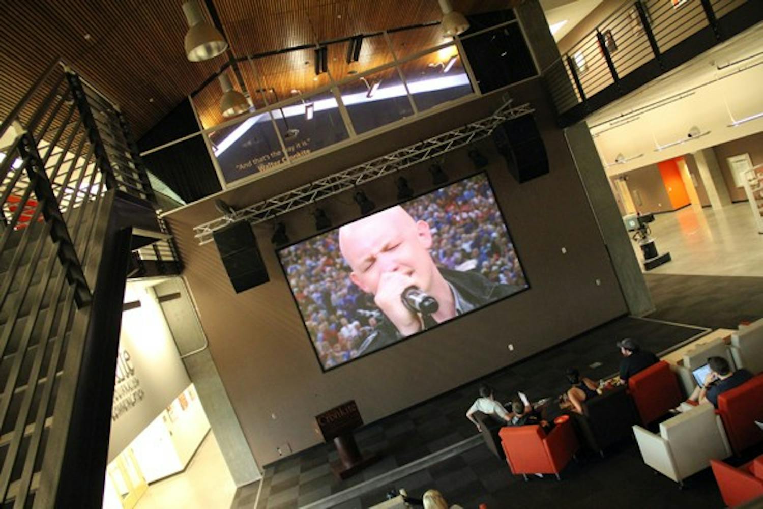 Students watch The Fray perform the National Anthem before the NCAA men’s basketball national championship in the First Amendment Forum at the Walter Cronkite School of Journalism and Mass Communication Monday night. (Photo by Diana Lustig)