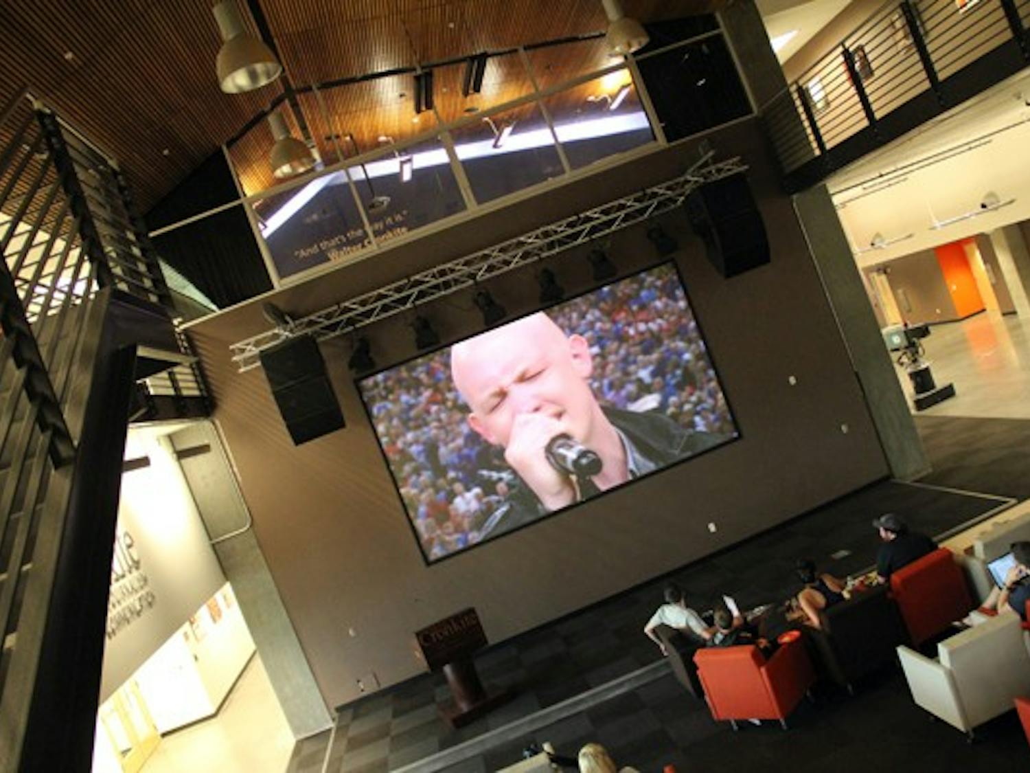 Students watch The Fray perform the National Anthem before the NCAA men’s basketball national championship in the First Amendment Forum at the Walter Cronkite School of Journalism and Mass Communication Monday night. (Photo by Diana Lustig)