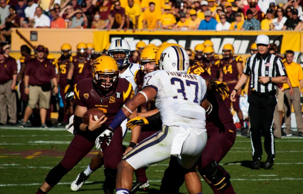Redshirt Junior quarterback Taylor Kelly carries the ball up the middle at a home game in Tempe against Washington. ASU won