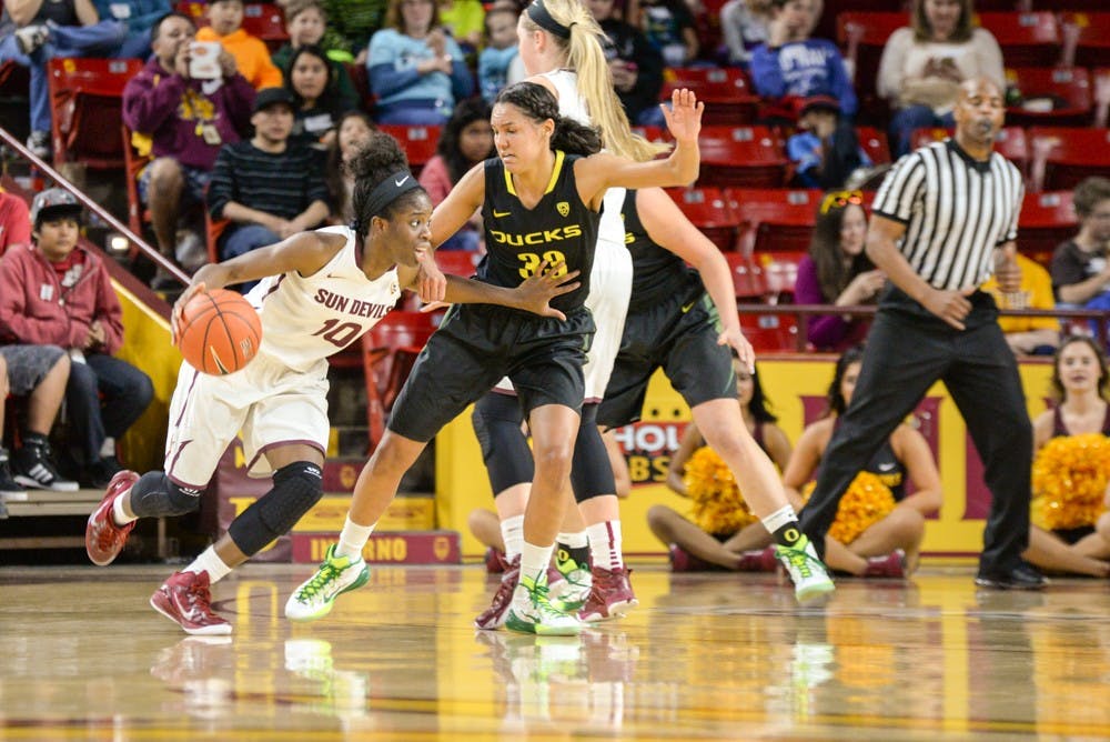 ASU senior Promise Amukamara pushes past an Oregon defender on Friday, Jan. 23, 2015, at Wells Fargo Arena. (J. Bauer-Leffler/The State Press)