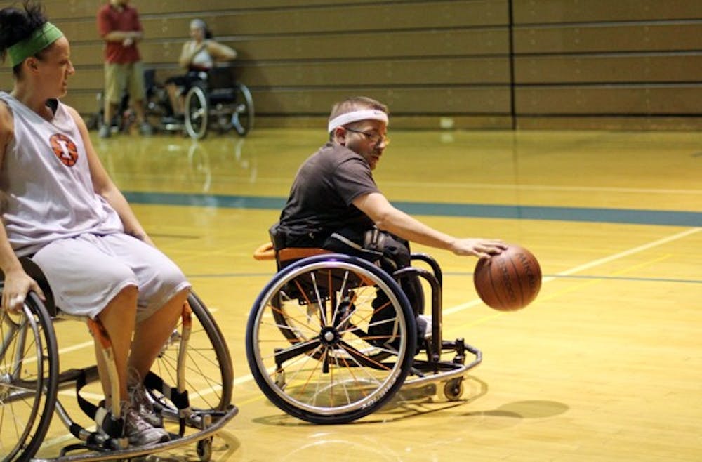 THE OTHER SUNS: Dustin Ferreira dribbles the ball away from the defense during a practice on Tuesday. Ferreira is a member of the Banner Wheelchair Suns of the National Wheelchair Basketball Association, a league that allows handicapped athletes to play the sport they love. (Photo by Lisa Bartoli)