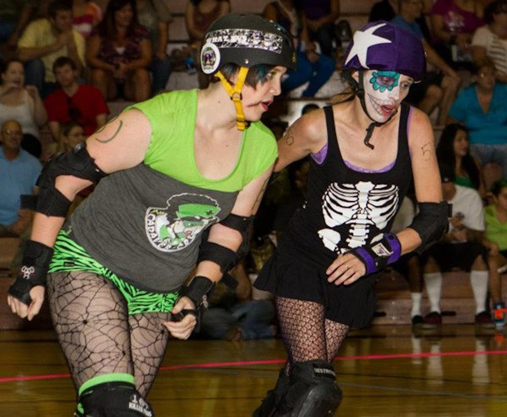 Geology major Sarah Gray attempts to block Lolitas de los Muertos' Jammer Allie Bye from scoring a point at a match in August.  (Photo courtesy of Devon Cadams)