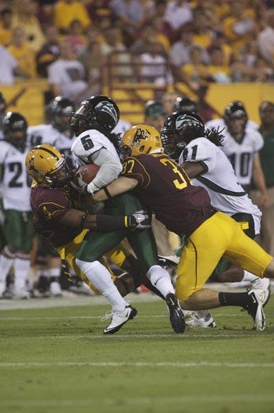STAYING FOCUSED: ASU freshman cornerback Alden Darby and redshirt senior safety Mike Callaghan tackle Portland State senior wide receiver Raymond Fry in last Saturday's game. The Sun Devils look to remain focused this week against Northern Arizona. (Photo by Scott Stuk)