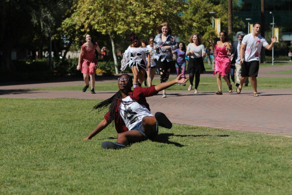 English literature and education Junior Jodi Walters falls down as a group of  students dressed as zombies chase her down. (Photo by Dominic Valente) 