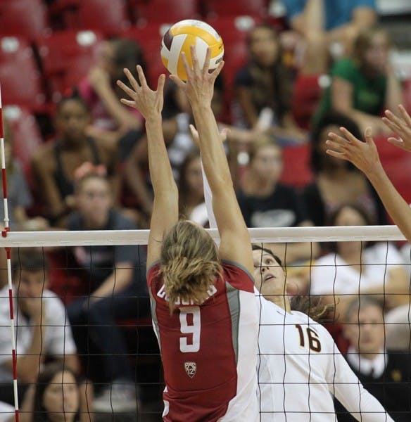 GETTING OVER: Sophomore outside hitter Danica Mendivil tips the ball over Washington State senior outside hitter Meagan Ganzer in the Sun Devils’ 3-2 loss to the Huskies. Coach Jason Watson said Mendivil has been finding her way back into the rotation and she helped ASU break their 11-game losing streak. (Photo by Rosie Gochnour)