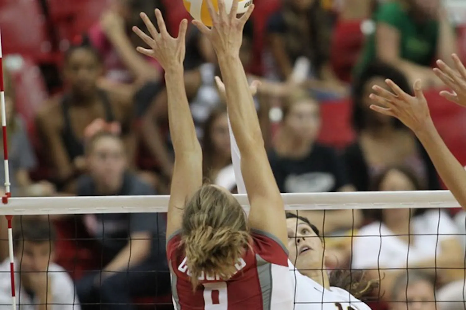 GETTING OVER: Sophomore outside hitter Danica Mendivil tips the ball over Washington State senior outside hitter Meagan Ganzer in the Sun Devils’ 3-2 loss to the Huskies. Coach Jason Watson said Mendivil has been finding her way back into the rotation and she helped ASU break their 11-game losing streak. (Photo by Rosie Gochnour)