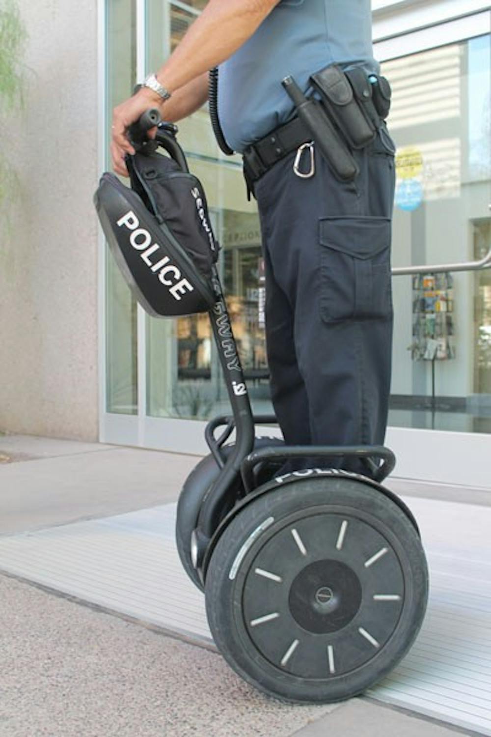 Police Aid Richard Bailey with the ASU Police Department rides around on his eco-friendly Segway to patrol the Tempe campus. (Photo by Robin Kiyutelluk)