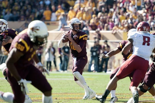 Quarterback Taylor Kelly drops back to pass before hitting wide receiver Cam Smith for a 42-yard touchdown in the second quarter of ASU's 52-31 win over Washington Stateon Senior Day at Sun Devil Stadium on Saturday, Nov. 22, 2014. (Photo by Mario Mendez)