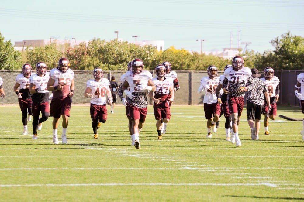 Defenders on the&nbsp;ASU football team warm up during practice outside the Verde Dickey Dome on March 18, 2016.