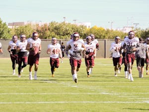 Defenders on the&nbsp;ASU football team warm up during practice outside the Verde Dickey Dome on March 18, 2016.