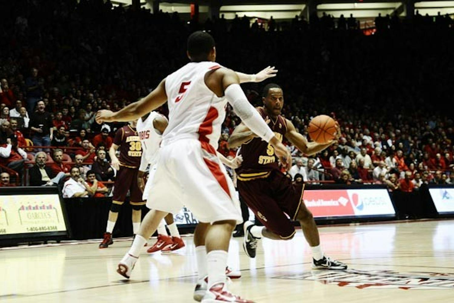 ROUGH ROAD: Freshman forward Kyle Cain dribbles into the lane as New Mexico senior guard Dairese Gary defends Tuesday night's Lobos win in Albuquerque. The Sun Devils open at home Saturday against Alabama-Birmingham, a team that has averaged 21.8 wins over the last seven seasons. (Photo Courtesy of the Daily Lobo)