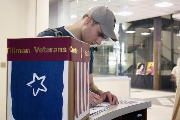 SENDING SUPPORT: Electrical engineering freshman Joel Wright , writes a letter to the troops overseas on Tuesday in the Memorial Union. Wright said he respects the people of the armed services and is thinking about one day joining the military. (Photo by Shawn Raymundo)