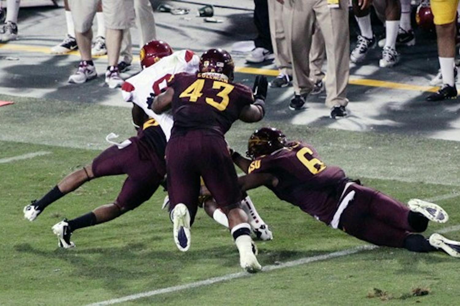 HELPING OUT: Sophomore defensive end Davon Coleman helps tackle a USC ball carrier during the Sun Devils’ 43-22 win over the Trojans on Saturday. Coleman is emerging as a force on defense this season since transferring from Fort Scott Community College in Kansas. (Photo by Beth Easterbrook)