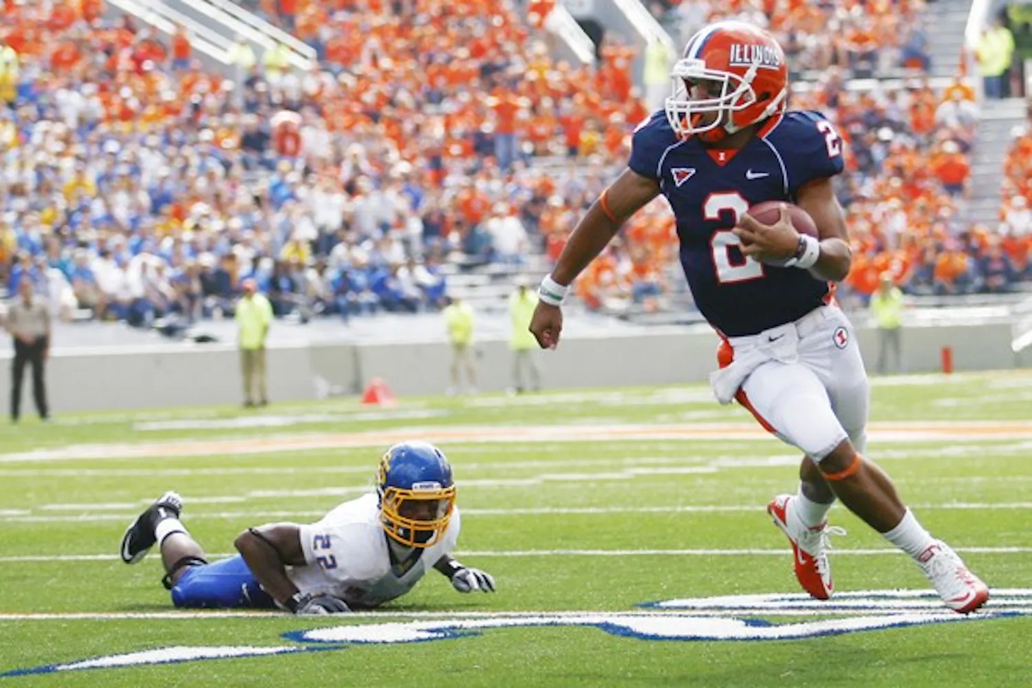 Daryl Quitalig The Daily Illini
Ilinois' Nathan Scheelhaase (2) runs past South Dakota State's Anthony Wise (22) at the game at Memorial Stadium. In this Saturday, September 10, 2011 game, the Illini won 56-3.