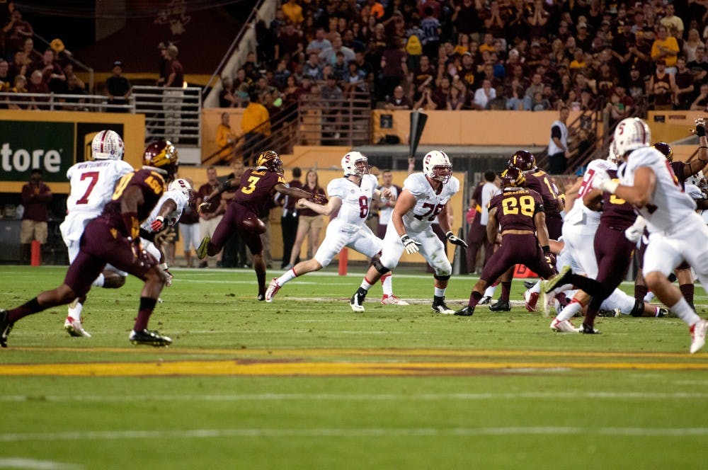 Defensive back Damarious Randall blocks Stanford quarterback Kevin Hogan. ASU beat Standford 26-10 at Sun Devil Stadium on Saturday, Oct. 18, 2014. (Photo by Mario Mendez)