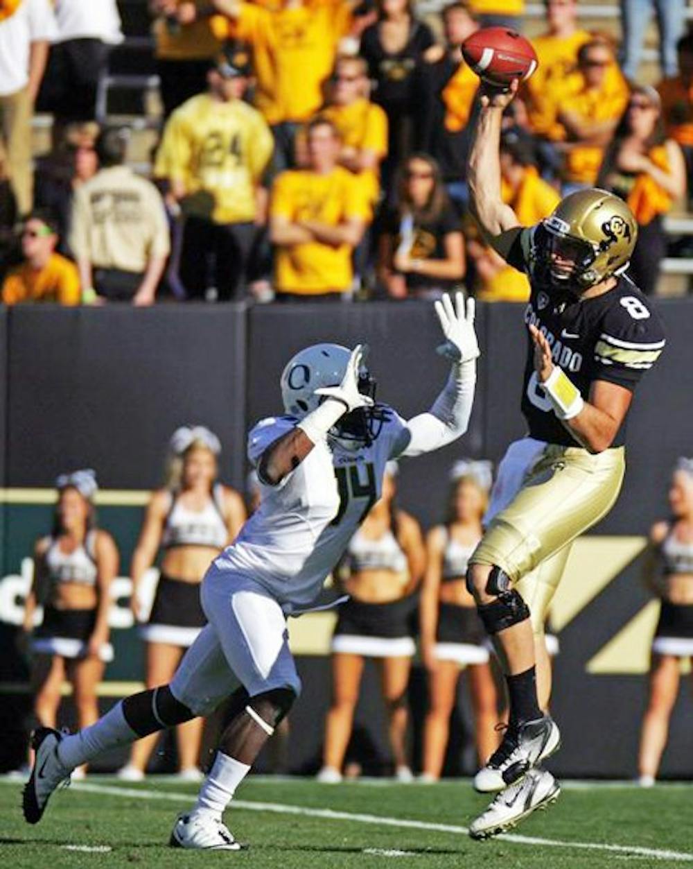 NOT QUITE SETTLED: Colorado Redshirt freshman quarterback Nick Hirschman gets pressured by Oregon cornerback Ifo Ekpre-Olomu during the Buffaloes’ 45-2 loss to the Ducks. The Buffaloes are looking for their first Pac-12 conference win against the Sun Devils on Saturday. (Photo courtesy of CU Independent | James Bradbury)