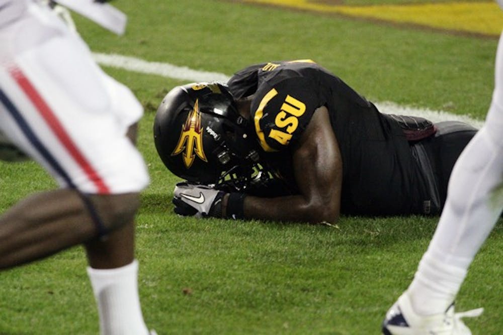 ASU senior wide receiver Mike Willie lays face down on the field after the Sun Devils’ loss to UA on Saturday. ASU had a chance to win with a last-minute drive, but were unable to score with two straight incompletions in the last nine seconds. (Photo by Elijah Grasser)