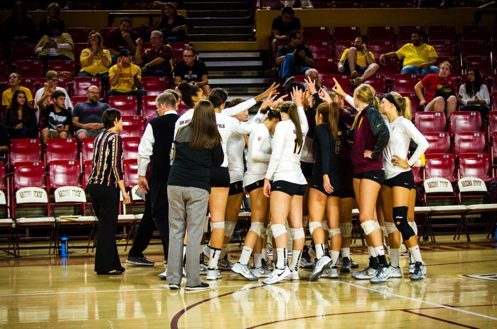 The ASU volleyball team holds up the pitchfork symbol before the start of a hard-fought 2nd set against Colorado.