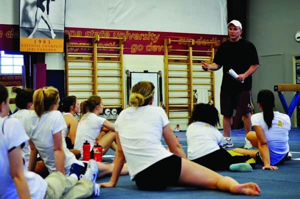 TEACHING LESSON: ASU coach John Spini talks to his team during a practice on Thursday. The Sun Devils have high goals for 2011, including returning to the NCAA Championships. (Photo by Sierra Smith)