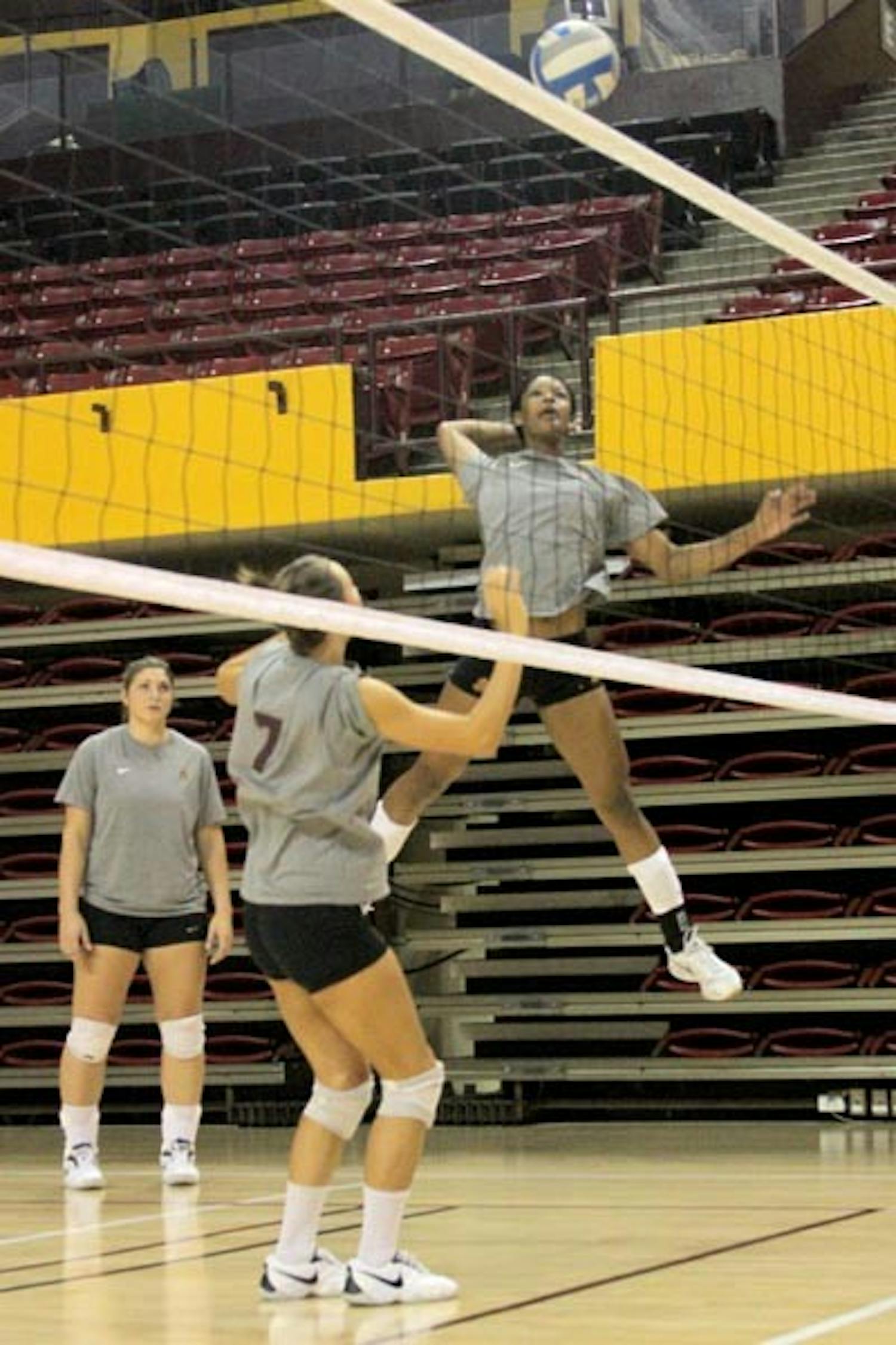 SET ON PERFECTION: Sophomore middle blocker Erica Wilson prepares a spike after a set up from junior setter Cat Highmark at practice last week. The Sun Devils open their season Friday at the Dayton Flyer Classic. (Photo by Andy Jeffreys)