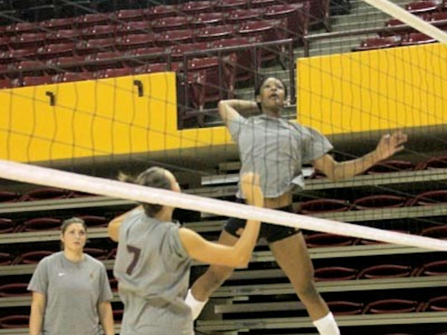 SET ON PERFECTION: Sophomore middle blocker Erica Wilson prepares a spike after a set up from junior setter Cat Highmark at practice last week. The Sun Devils open their season Friday at the Dayton Flyer Classic. (Photo by Andy Jeffreys)
