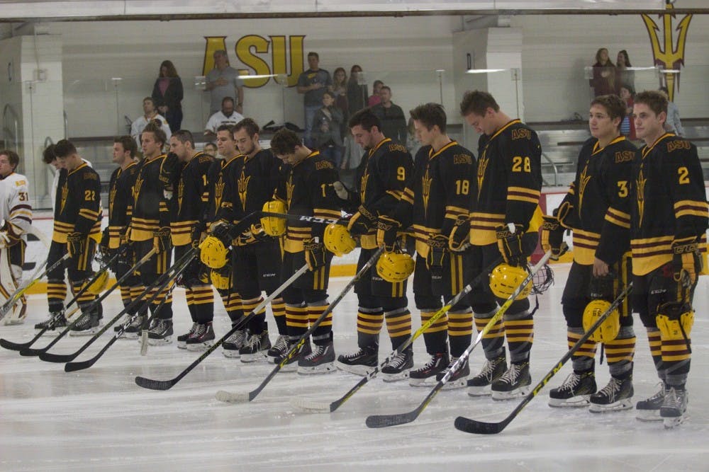 The ASU men's hockey team (gold) stands at center ice for the National Anthem before the annual Maroon and Gold Scrimmage at Oceanside Ice Arena, in Tempe, Arizona on Saturday, Oct. 1, 2016. The maroon team won 4-3 in overtime.