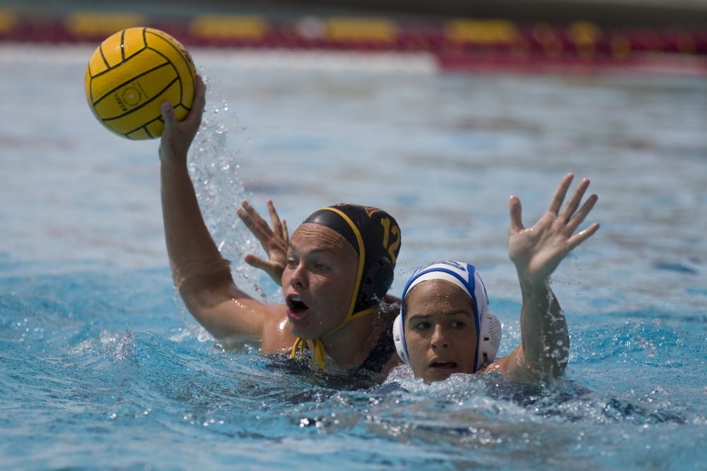 ASU freshman Bente Rogge (12) fights off a Bruins defender during a water polo match versus the no. 3 UCLA Bruins at Mona Plummer Aquatic Center in Tempe, Arizona on Saturday, April 8, 2018. ASU lost 13-5.
