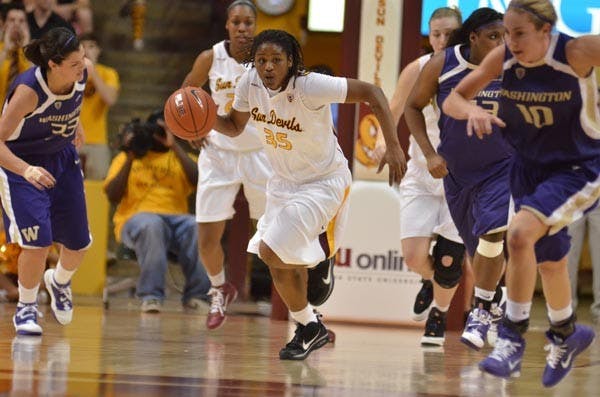 Grinding it out: ASU senior guard Tenaya Watson drives down the court during the Sun Devils’ 52-49 win over visiting Washington on Saturday. Solid defense carried the game for ASU, as the offense shot just 33.3 percent from the field. (photo by Aaron Lavinsky)