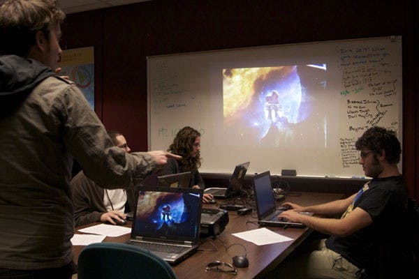 Students in the computer gaming, learning and literacy class play video games to learn strategy for real life situations. Some students play the game while others observe.  Creative writing and communications senior Tyler Fleck directed his team on what to do while playing Spaceship Artimes. Computer science sophomore Alex Rempel on the right, computer science junior Andrew Melnik on the left and digital cultures sophomore Katrina Peters in the back. (Photo by Ana Ramirez)