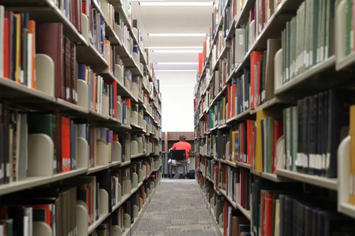 FINALS STRESS: A student studies at the library. The amount of people at the library will be increasing in the next week because of finals. (Photo by Nikolai de Vera)