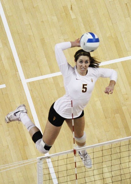 Junior middle blocker Alexis Pinson goes up for a spike as freshman setter Allison Palmer watches in anticipation during an ASU victory in its own Sheraton Invitational on Sept. 14.  (Photo by Kyle Newman)